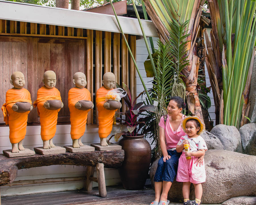 Four little monk statues and visitors